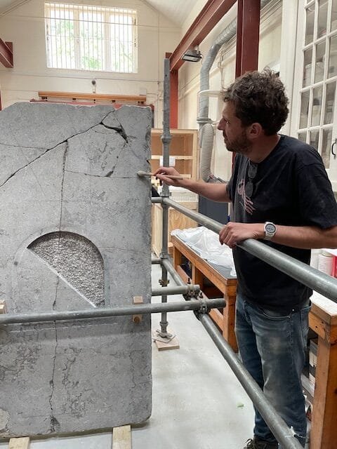 The stone undergoing cleaning and restoration in 2025